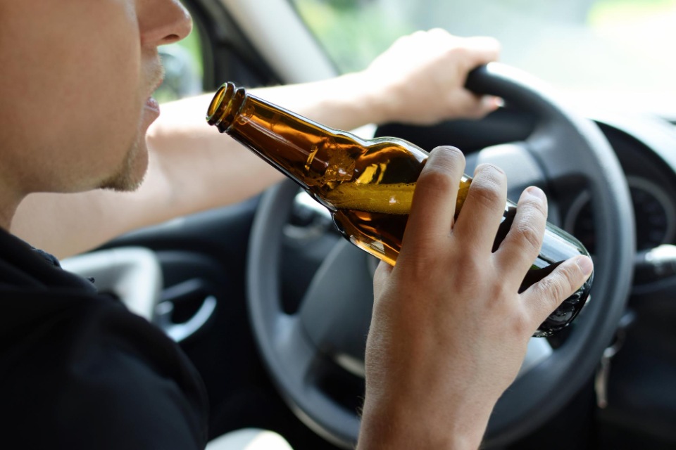 California DUI Attorneys | Man driving car while drinking alcohol | Her Lawyer